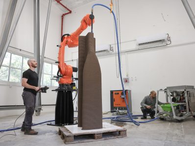 Two men operating robots