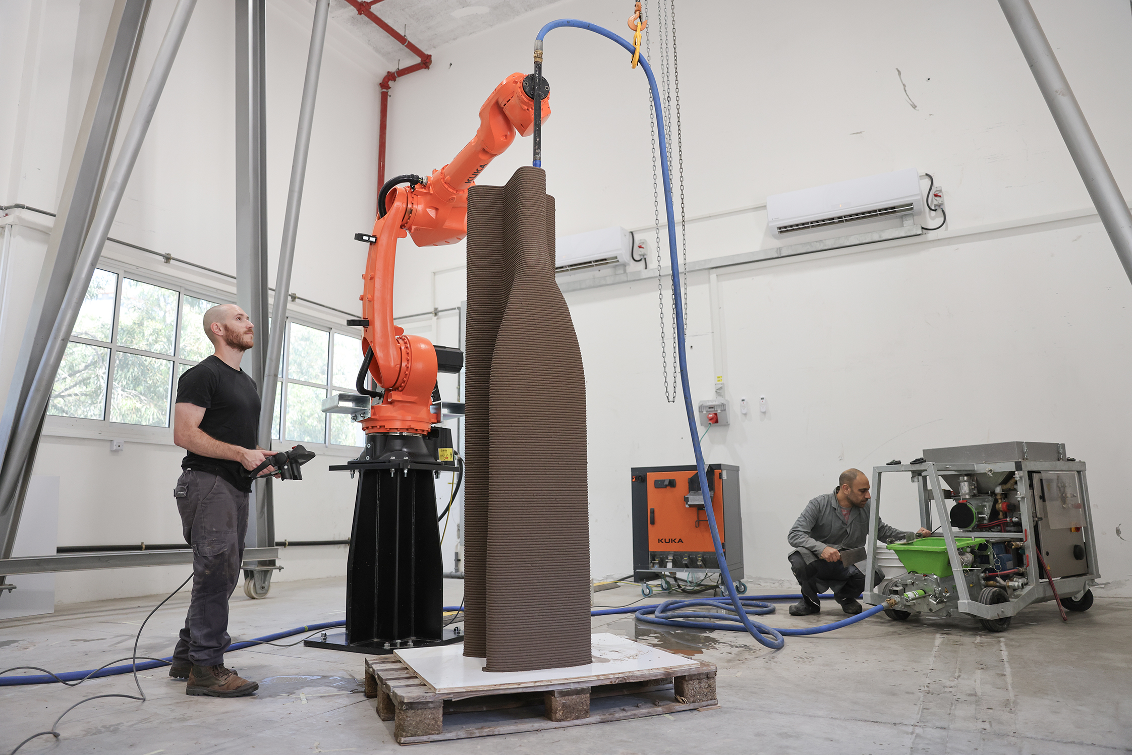 manufacturing robot half kr50 Two men operating robots